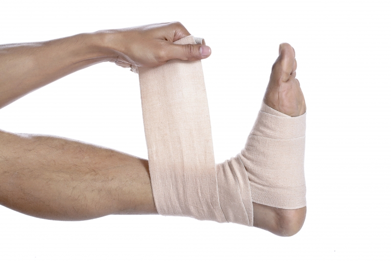 4003375-guy-placing-a-tensor-bandage-on-his-feet